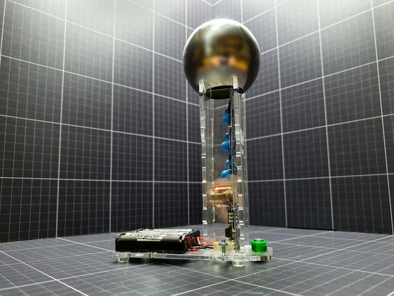 A  175mm tall, high voltage generator that will achieve 30,000 to 40,000 volts of "static" electricity. With no mechanical parts. The Cockcroft Walton Multiplier is a safe, current limited high voltage generator for home lab or classroom. It is capable of providing the high voltage for all the experiments that can be done with the 150mm Van De Graaff, but as there is no reliance on triboelectric charging it does not require the low humidity and scrupulous cleanliness and so removes many of the problems associated with traditional Van de Graffs.

Unusually for a Cockcroft Walton Multiplier the high voltage is delivered to a small Van de Graaff dome to ease its use with experiments intended for a classic VDG