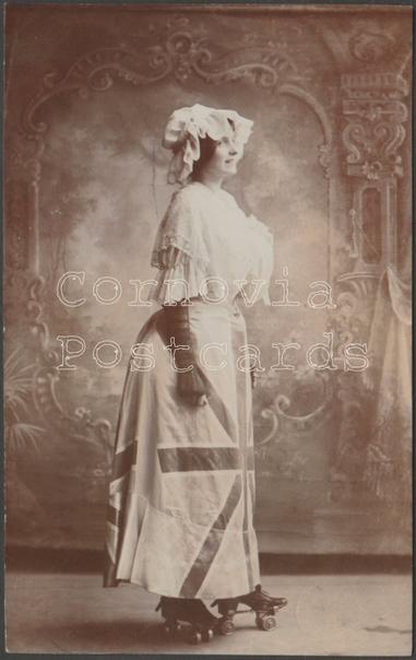 Sepia real photographic postcard showing a view of a lady in bonnet and a Union Jack skirt on roller skates.

Published by Southwood, Woodford Road, Watford, not numbered, c.1905-10.

Postally unused.

Very good condition, with minimal corner bumps and light album marks, but very light bend to upper right centre. The Cornovia Postcards watermark is for image protection and does not appear on the actual card.