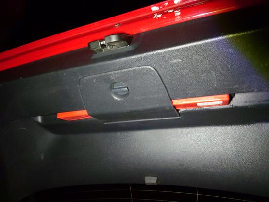 The warning triangle in its holder below the tailgate
