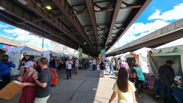 Pedestrians under I83 strolling through Artscape.