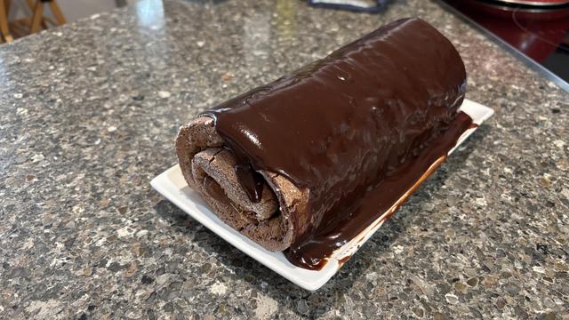 Chocolate Swiss roll with too much chocolate glaze poured on top