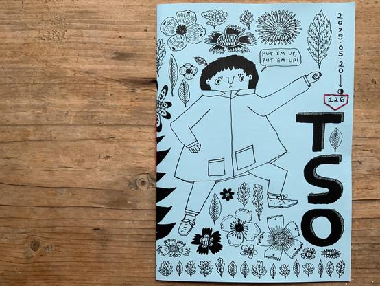 The cover of an illustrated zine, with detective Tso in a fighting position saying, put ‘em up, put ‘em up!