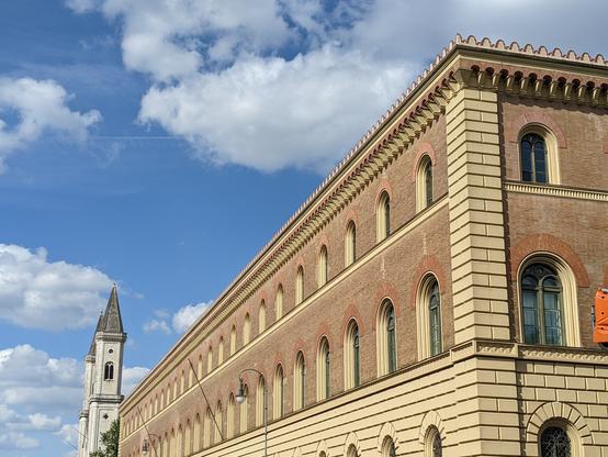 Old historic public building with church on Munich's Leopold Street