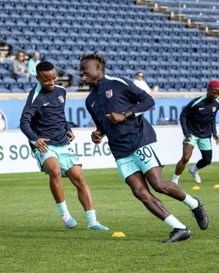 Lacho and Jereko laughing during warmups