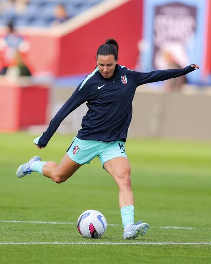 Action photo of DiBernardo shooting during warmups