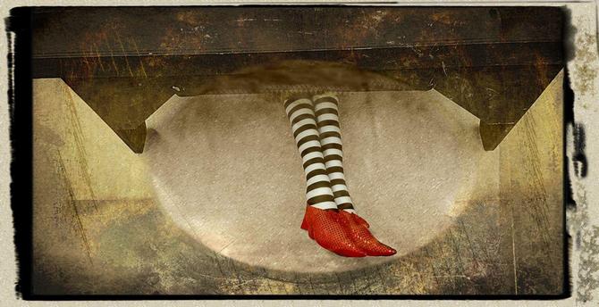 Legs wearing striped stockings and ruby slippers stick out from under a table.
