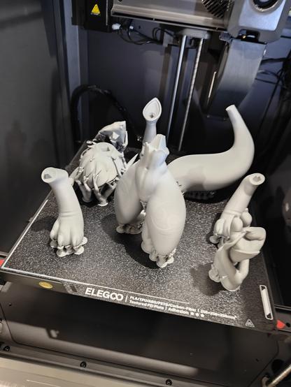 pieces of a 3D printed Renamon on a FDM build plate.