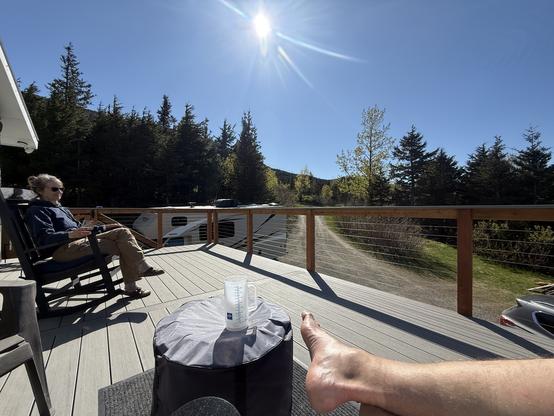 Brilliant blue skies, not a cloud, just the bright sun as my wife and I sit on the front deck enjoying a beautiful day.  There might be a large cocktail sitting on the solo stove cover.
