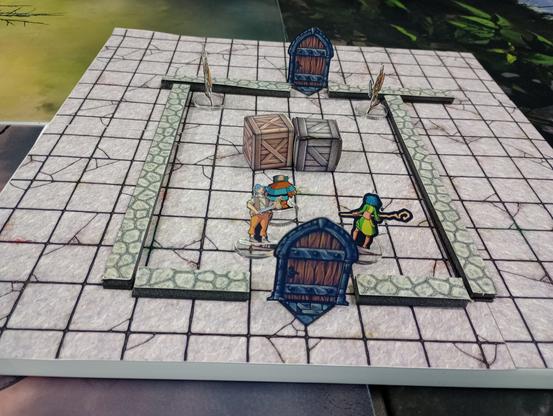Paper miniatures on a magnetic dungeon sheet with paper scenery including 2 doors, some crates, and some skeletons.