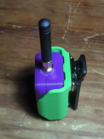 A camera angle looking downward from the side shows the spring-loaded belt clip which is bolted to the back of the holster.