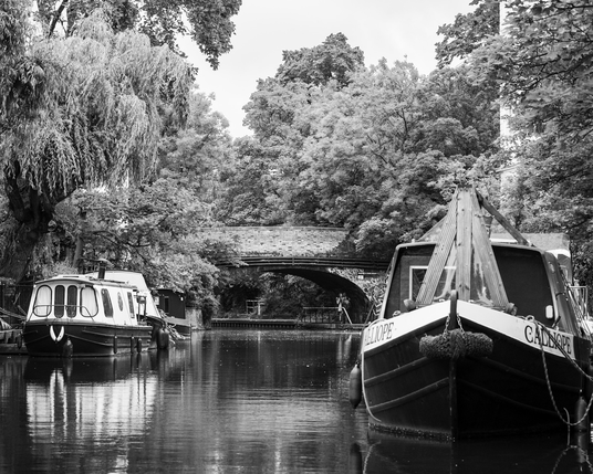 Black and white canal boats and bridge