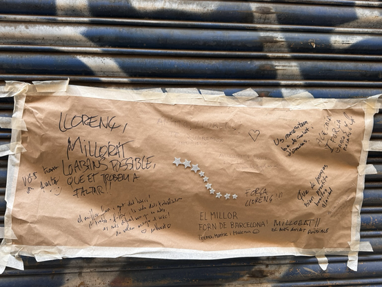 Notes from neighbors on the door of a bakery closed due to the illness of the owner.