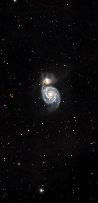 A spiral galaxy, partially illuminated, is set against a dark, starry background. The galaxy features a bright center with swirling arms and several distant stars scattered throughout the image.

Galaktyka spiralna, częściowo oświetlona, jest osadzona na ciemnym, gwiaździstym tle. Galaktyka ma jasne centrum z wirującymi ramionami i kilkoma odległymi gwiazdami rozrzuconymi po całym obrazie.