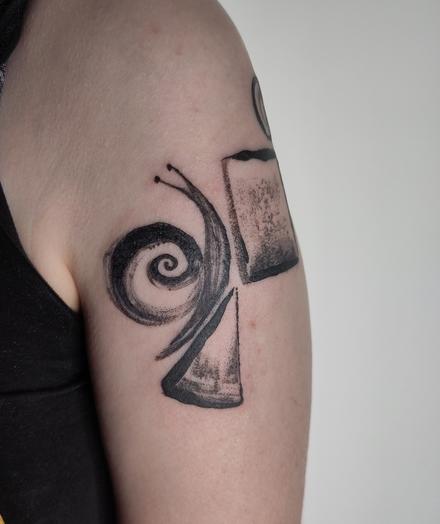 Tattoo of a snail crawling on a stack of shapes