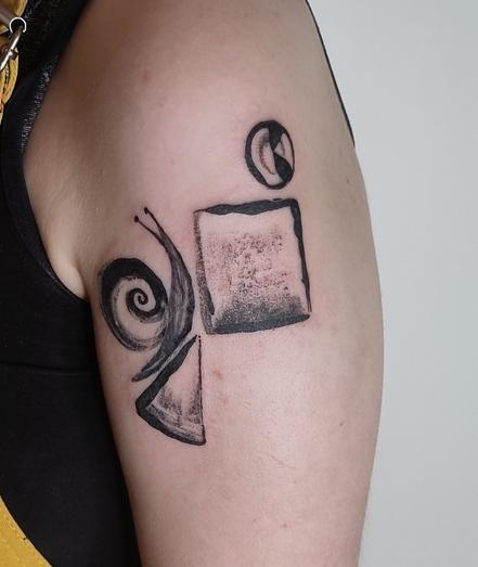 Tattoo of a snail crawling on a stack of shapes
