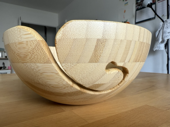 The finished result: a smooth curl ending in a hole (looking a bit like an ear), on a table