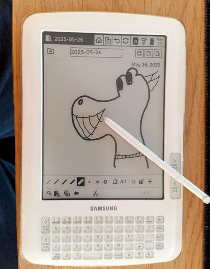 Same reader, now cleaned. Someone drew a weird character in the note taking app with the included digitizer pen, which still rests on the display.