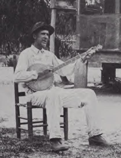 Photo of Hamp Mizell strumming his homemade banjo. May 1930. Taken by naturalist Francis Harper and featured in his book "Okefinokee Album"