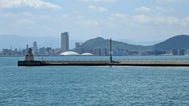 The Kagawa Arena seen from Megijima's port. There's also Takamatsu skyline as well as the Oni Lighthouse from Megijima.