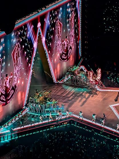 Beyoncé suspended above the stage in a giant illuminated horseshoe and projected onto the screens, her dancers walking along the edge of the stage