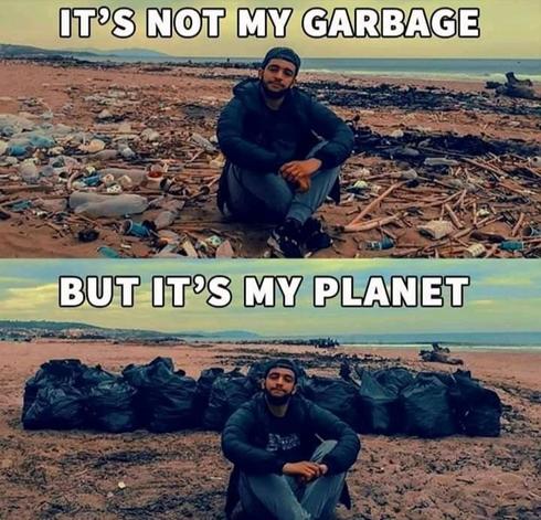 A split image showing a man sitting on a beach. In the top part, the beach is covered with litter and debris, with the text "IT'S NOT MY GARBAGE" in bold white letters above. In the bottom part, the beach is clean, with several large garbage bags filled with trash lined up behind the man. The text above reads "BUT IT'S MY PLANET" in bold white letters. The man is wearing a cap, a jacket, and sits cross-legged in both images. The background features a shoreline and a cloudy sky.
