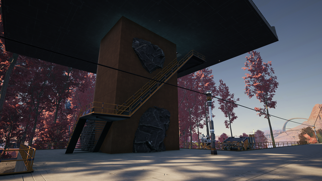 A lookout tower has exposed stone on its concrete wall providing some decoration for users traversing the stairs.  The Red Bamboo forest is in the background.