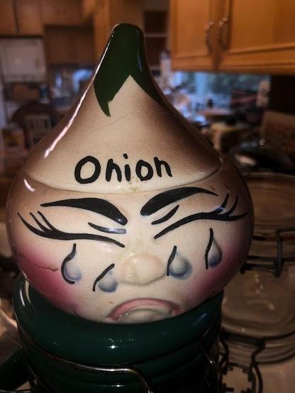 Ceramic onion keeper[?] in the shape of a crying onion