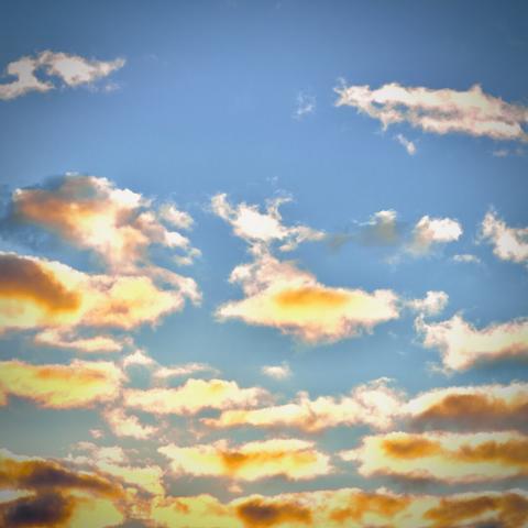 Bright orange clouds dot a blue morning sky.