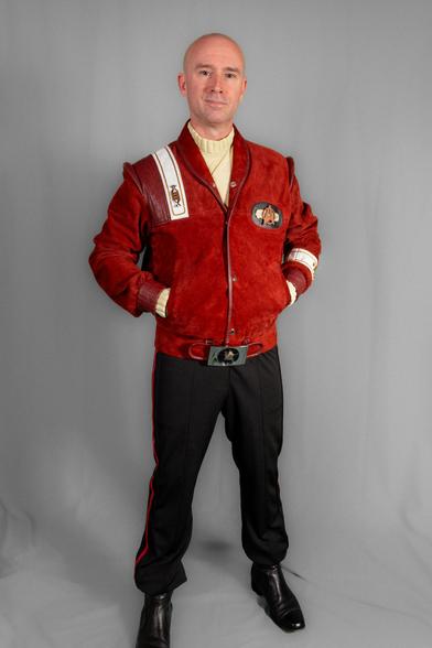 Photo of myself standing with my hands in the pockets of a maroon bomber-style jacket with Starfleet insignia over a ivory turtleneck and black uniform-pants.