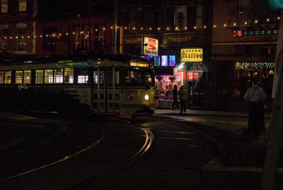 A night photo of the F Market streetcar at the Castro turnaround, captured at high ISO