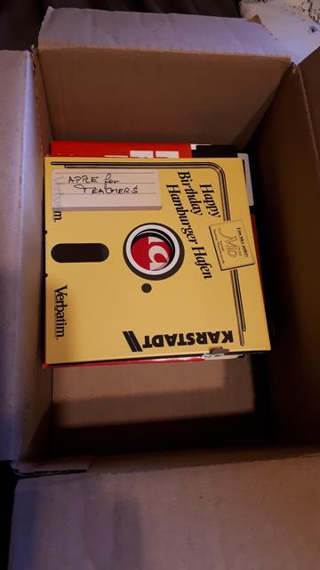 a box with 5 1/4 inch floppies. On top a yellow paper disk printed with "Happy Birthday Hamburger Hafen" with an ad for Karstadt