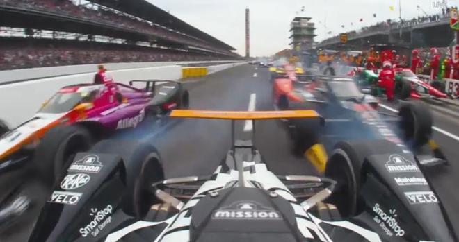 Rear-facing view leaving the pit lane with two other cars only several inches away.