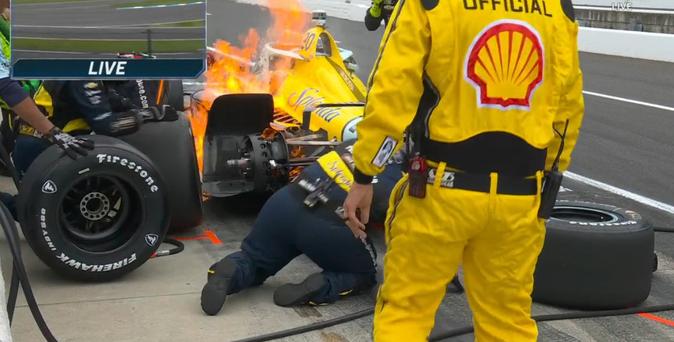 Fire breaks out on Alexander Rossi's IndyCar during a pit stop.