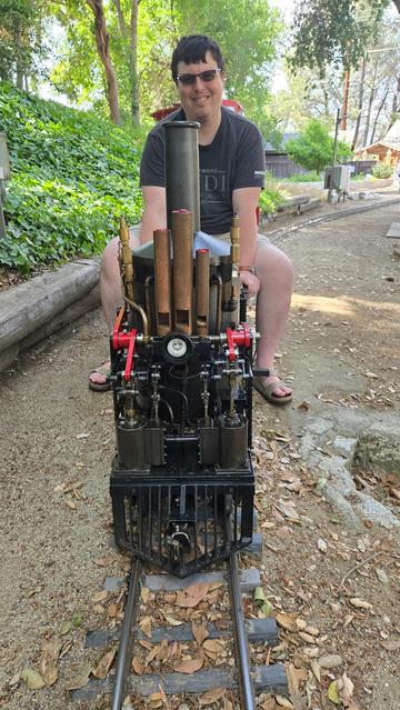 Me in the engineer's seat of a ride-on vertical boiler steam locomotive