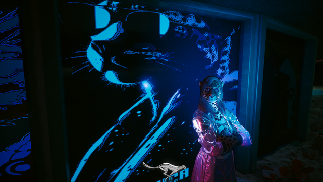 Cyberpunk 2077 photo mode picture. V, a spotted feline wearing sunglasses, leans with arms crossed against a neon blue billboard/poster depicting a spotted feline also wearing sunglasses.
