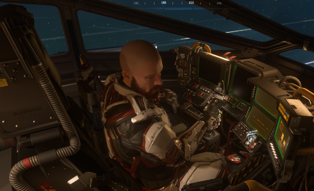 Star Citizen Screenshot: Ein glatzköpfiger, bärtiger Mann sitzt im Pilotensessel.