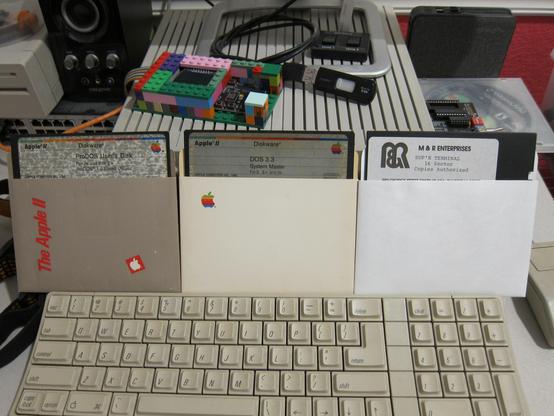 Apple II series originals. ProDOS User's Disk, DOS 3.3 System Master, SupRTerminal software.