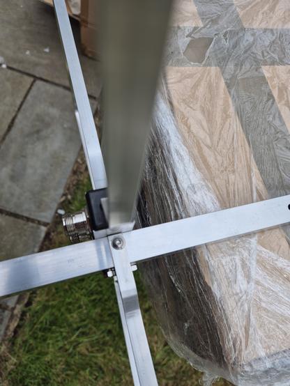 Close up showing vertical radiator blocking vertical access to the screw