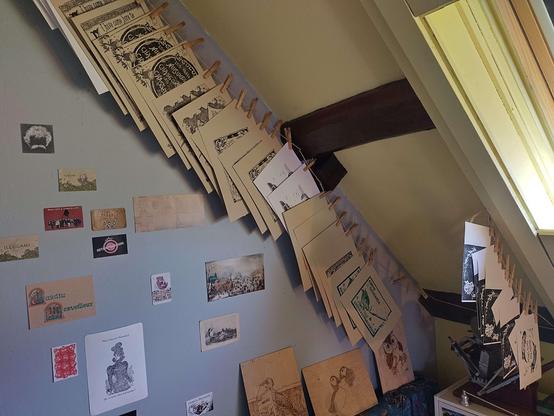 Piles of prints drying under the slope of the roof on my landing.