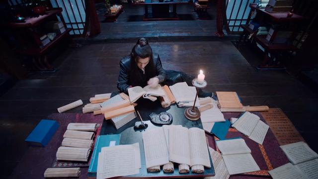 In the Wen supervisory office library, Wei Wuxian is surrounded by a disarray of scrolls and tomes, desperately searching for a solution.