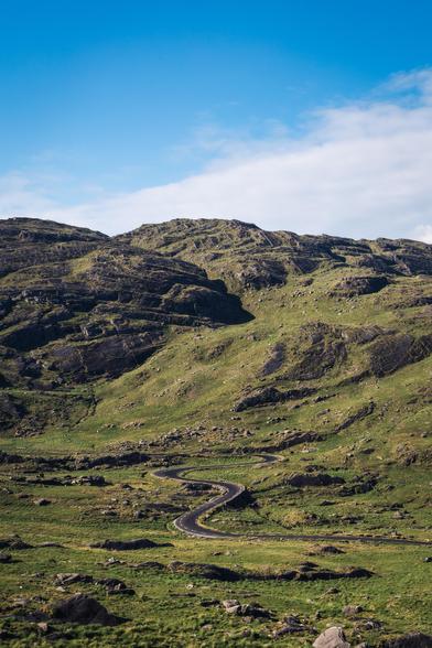 a narrow, windy road in a valley