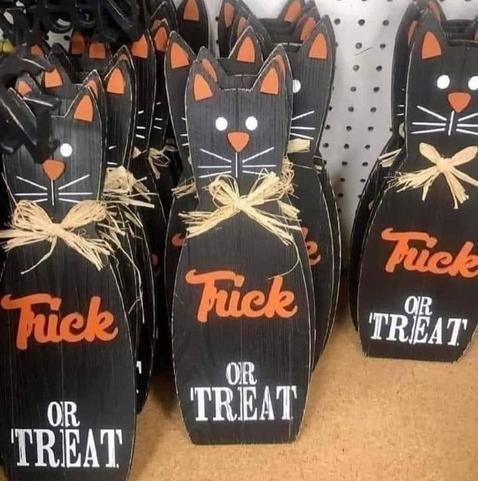 black Halloween cat signs being sold that should say "Trick or treat" but appear to say "F*ck or Treat"