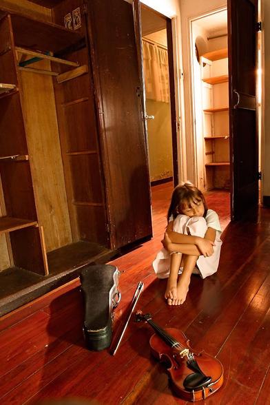 A barefoot 7 year old girl wears a white  dress. She sits quietly on a old wooden floor while holding her legs. A violin, arch and worn case lay in front of her. To her right there is an empty old cedar armoir with both doors open. The old room is backlit from an open closet behind her. The walls show some humidity, yet the feeling is one of warmth and serenity. EOS D60 (6.3 MP!) Sigma 14mm EX @F8, 30 sec exposure. If there is interest i will upload more from this series taken at my grandmothers house after she passed away (the model is my daughter).