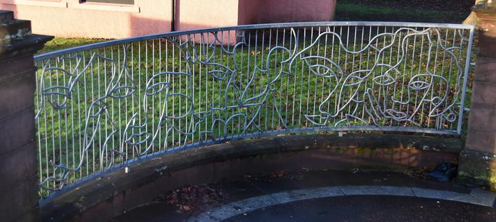 A decorative metal railing showing multiple faces in Glasgow Scotland