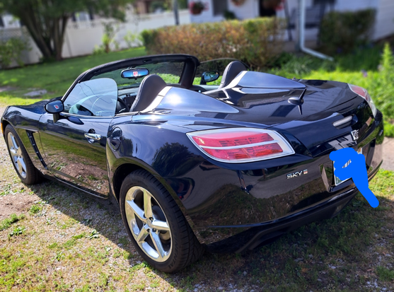 A shiny blue 2007 Saturn Sky convertible roadster.