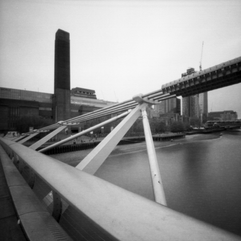 Photograph through the cables of the millennium bridge with the Tate Modern in the background