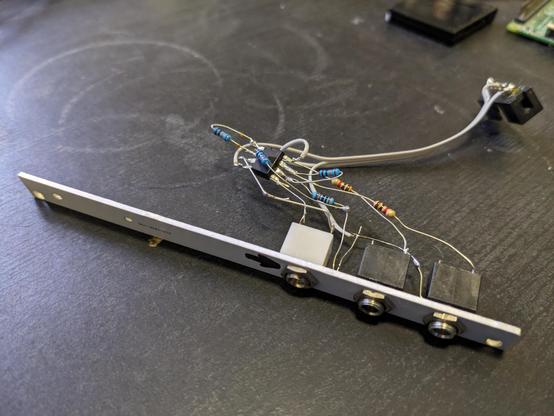 a eurorack module laying on the side revealing that there's a messy nest of resistors and an IC soldered directly to each other without any PCBs