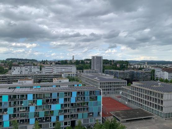 blick auf ein neubauquartier einer stadt mit grossen wohnblöcken mit flachdächern. meist mit sonnenkollektoren bestückt.