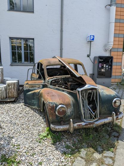 Oldtimer car ruin carcass outside of Exhibition space for everything cars at Motorworld Munich with bars cafes restaurants and lots of cars and equipment old and new but mainly expensive