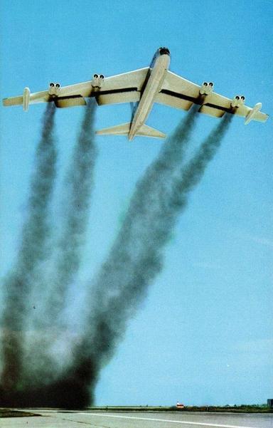 A vertical card. The plane is taking off and there is black smoke trailing from the 8 engines.